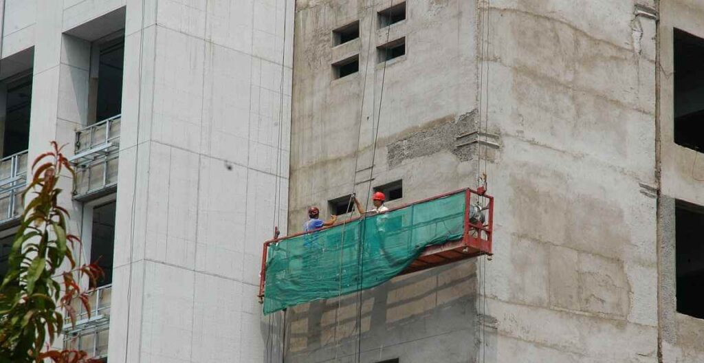 Worker works on industrial building